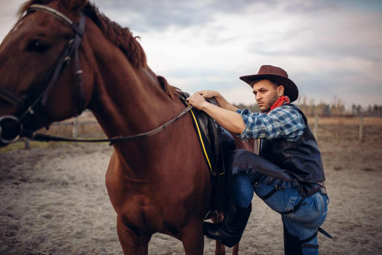 man climbing on a stirrup