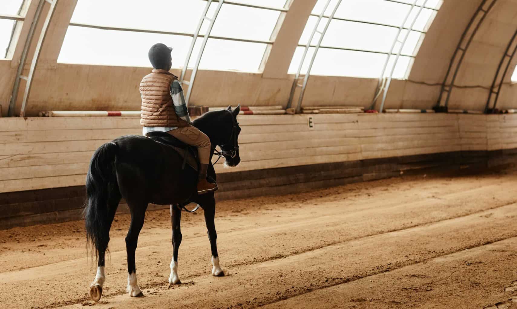 Woman Riding Horse Indoors